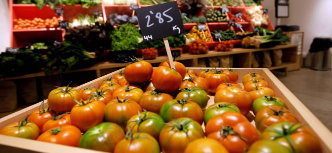 Una frutería con tomates en venta