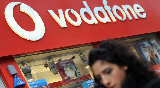 Un transeúnte camina frente a una tienda de Vodafone. EFEArchivo
