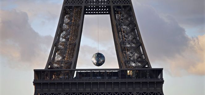 Una esfera cuelga entre el primer y el segundo piso de la torre Eiffel en París, con motivo de la COP21.