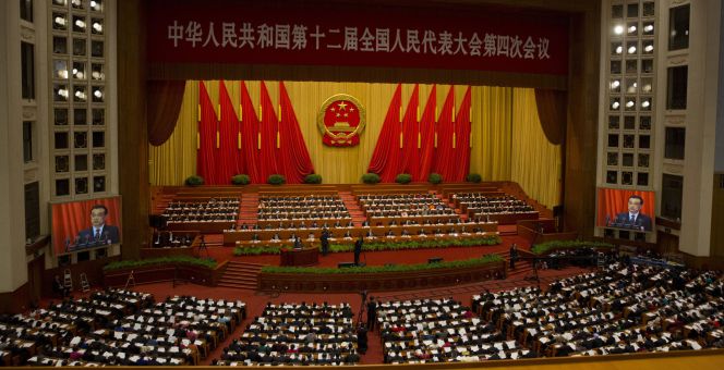 Chinese Premier Li Keqiang appears on big screens as he delivers the work report at the opening session of the annual National People's Congress in Beijing's Great Hall of the People, Saturday, March 5, 2016.(AP PhotoNg Han Guan)