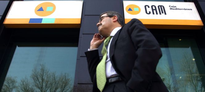 Una persona camina frente a una sucursal de Caja Mediterráneo (CAM), en 2010.