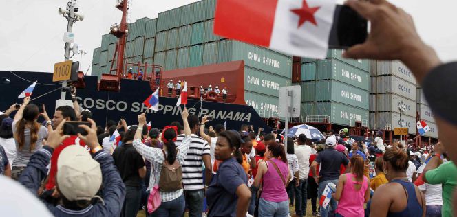 Panameños observan el buque Cosco Shipping Panamá durante el tránsito inaugural por la esclusa de Agua Clara en el Canal de Panamá Ampliado, el domingo.