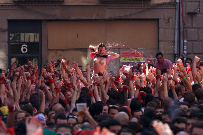 PAMPLONA, SPAIN - JULY 06: (EDITORS NOTE: Image contains nudity) Revellers enjoy the atmosphere during the opening day or 'Chupinazo' of the San Fermin Running of the Bulls fiesta on August 6, 2016 in Pamplona, Spain. The annual Fiesta de San Fermin, made famous by the 1926 novel of US writer Ernest Hemmingway entitled 'The Sun Also Rises', involves the daily running of the bulls through the historic heart of Pamplona to the bull ring. (Photo by Pablo Blazquez DominguezGetty Images)
