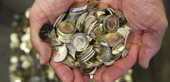 Un hombre sostiene varias monedas de euro. EFEArchivo