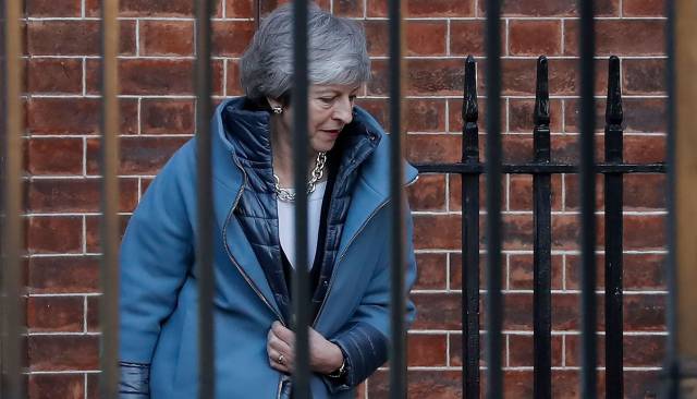 Britain's Prime Minister Theresa May leaves from the rear of 10 Downing Street in London on February 14, 2019 ahead of a vote on amendments to the Brexit withdrawal bill. (Photo by Tolga AKMEN AFP)