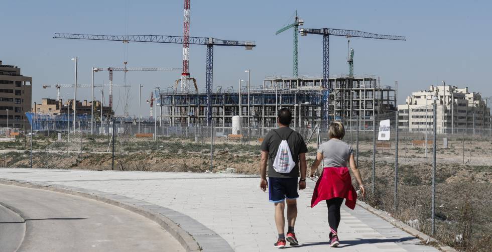 Dos personas pasean por barrio del Cañaveral (Vicálvaro), en plena construcción.
