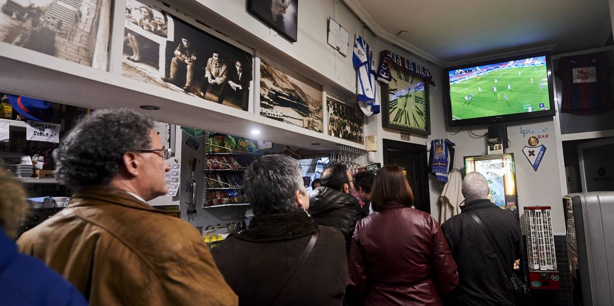 Clientes de un bar siguen la emisión de un partido de fútbol