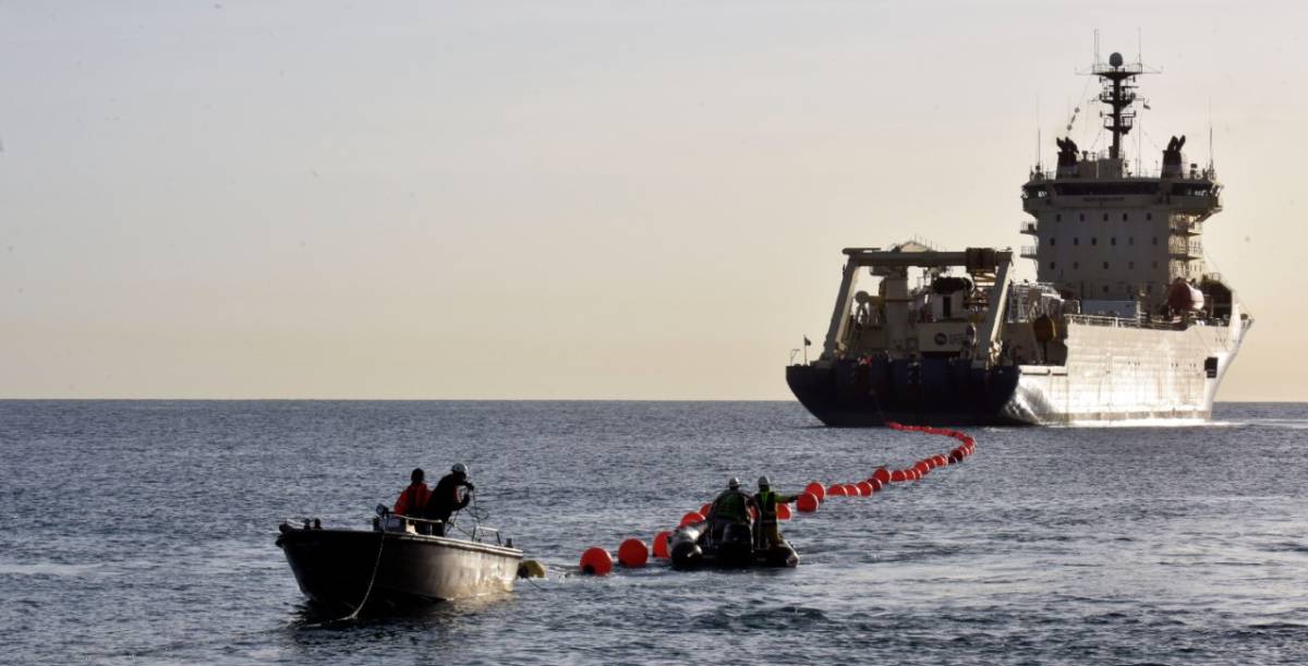 Un barco lanza un cable submarino en Barcelona.