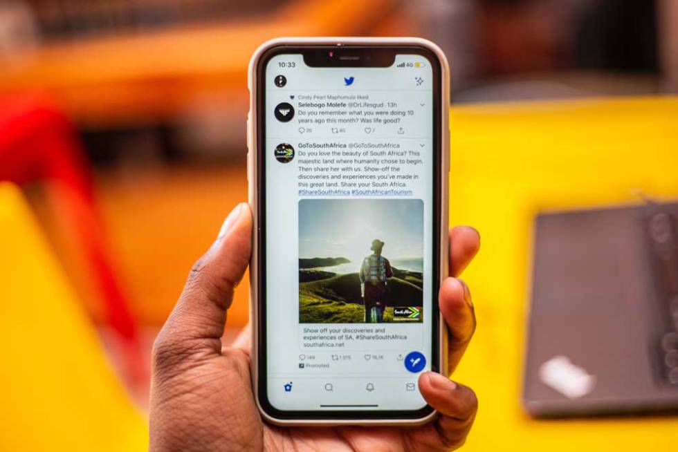 Twitter on a phone in hand